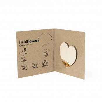 Corazón de madera natural con semillas de flores silvestres para plantar